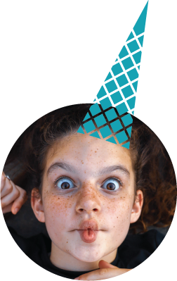 A girl making a fish face with an ice cream cone hat at Modelland